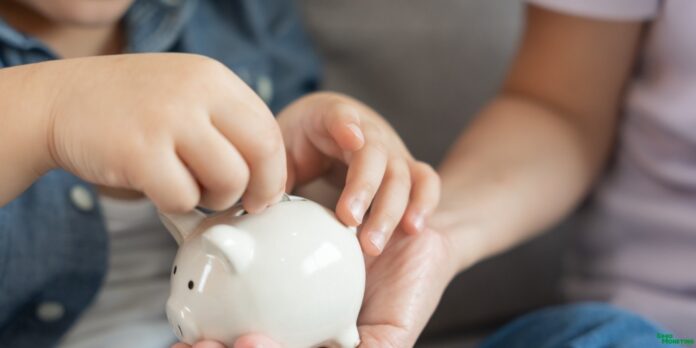 Mother helping child save money in a piggy bank, teaching about financial planning for education.